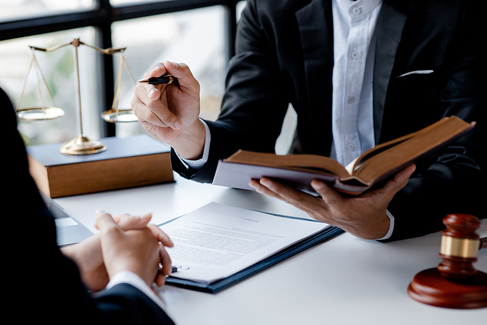 Two,Lawyers,Are,Reading,A,Large,Book,Of,Law,To